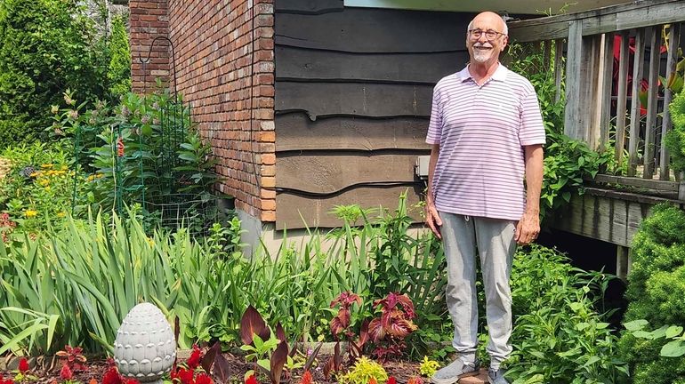 Jeff Kellert stands in his garden at his home in...