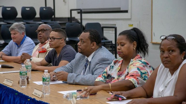 From left, special adviser Jack Bierwirth and Hempstead school board members...