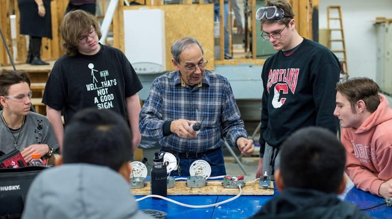 Teacher Fred Castro, 77, instructs students during a lesson in...