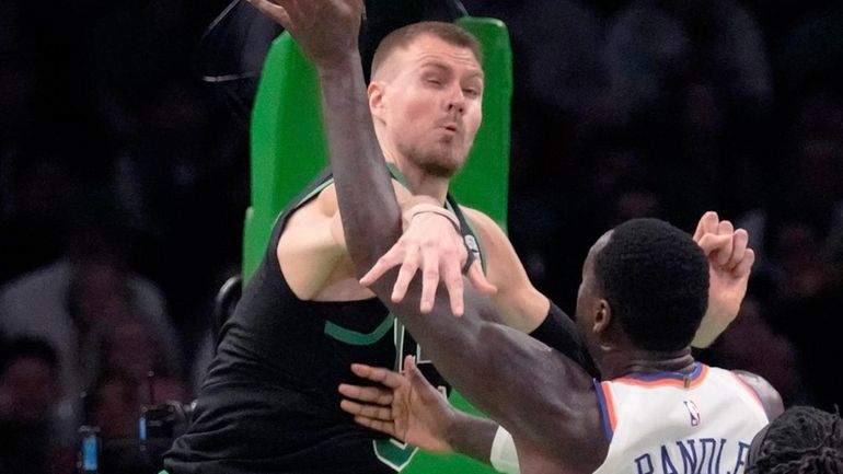 Celtics center Kristaps Porzingis, top left, blocks a shot by Knicks...