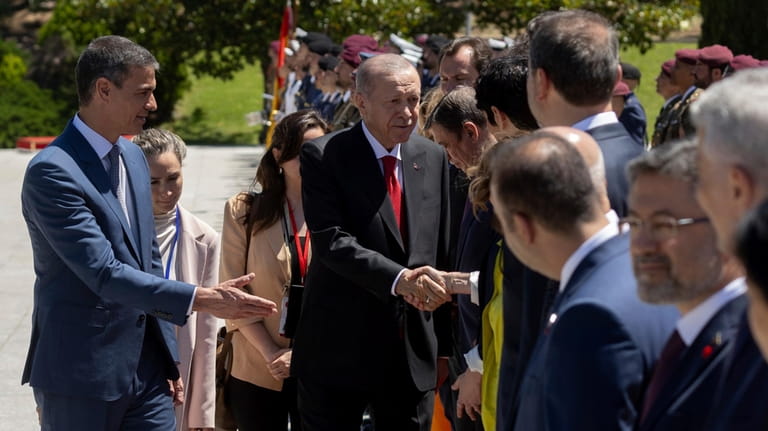 Spanish Prime Minister Pedro Sanchez, left, introduces Turkish President Recep...