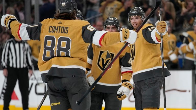 Vegas Golden Knights defenseman Ben Hutton, right, celebrates after scoring...