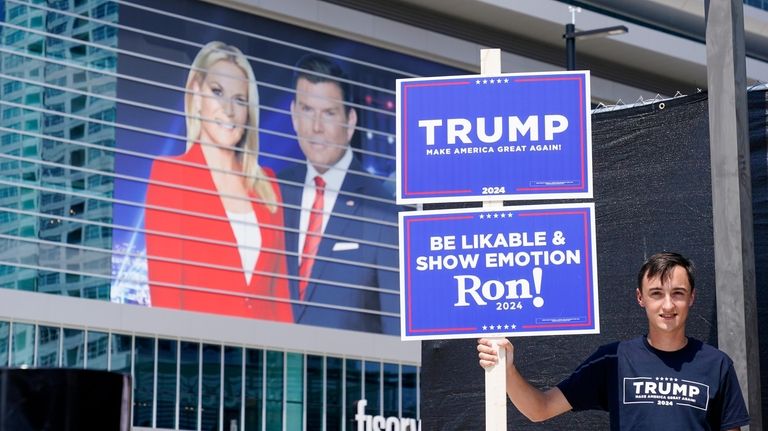 A former president Donald Trump supporter stands near the Fiserv...