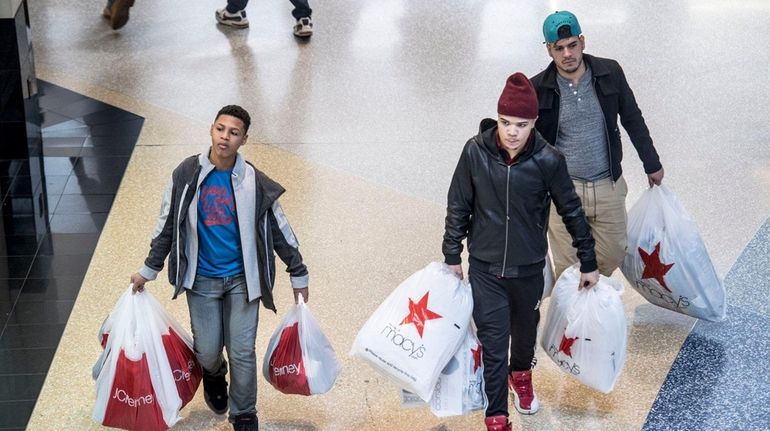 Shoppers hunt for bargains on Black Friday, Nov. 25, 2016,...