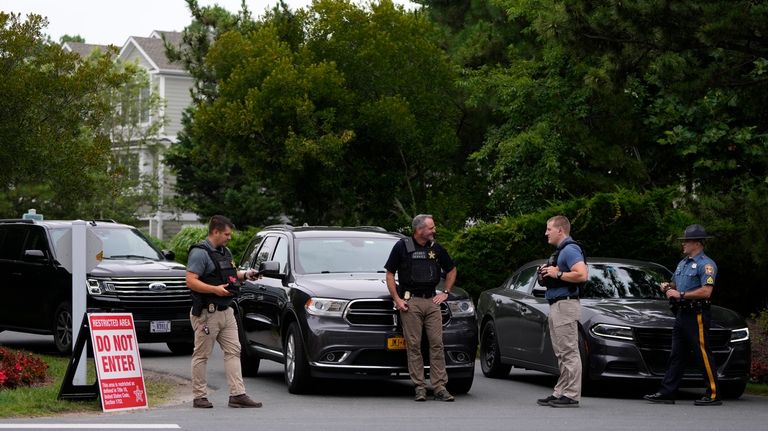 Law enforcement blockades a street near President Joe Biden's beach...