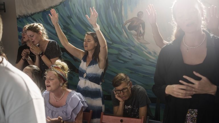 Marielle Louw, raised hands, and Andries Louw, missionaries from South...