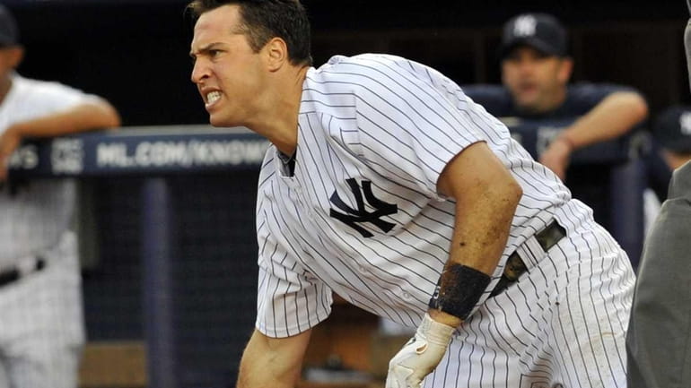 Mark Teixeira grimaces in pain and anger after he was...