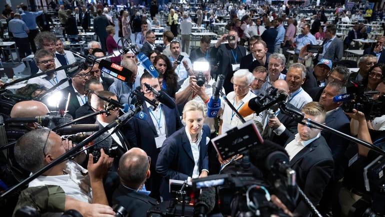 AfD's Alice Weidel, centre, answers journalists' questions after her election...