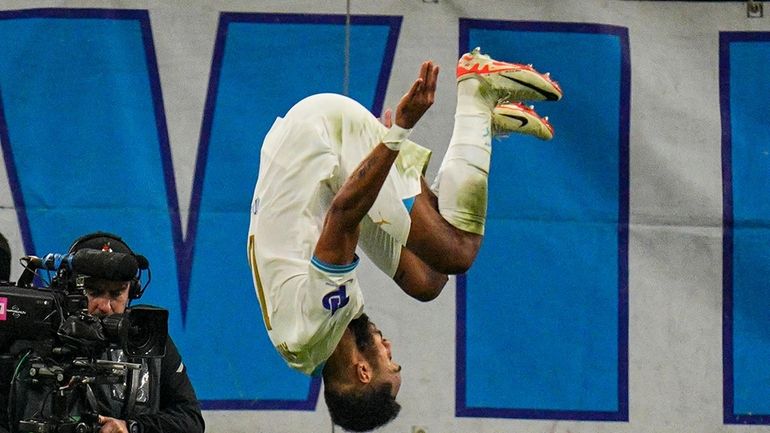 Marseille's Pierre-Emerick Aubameyang, centre, celebrates after scoring his side's fourth...