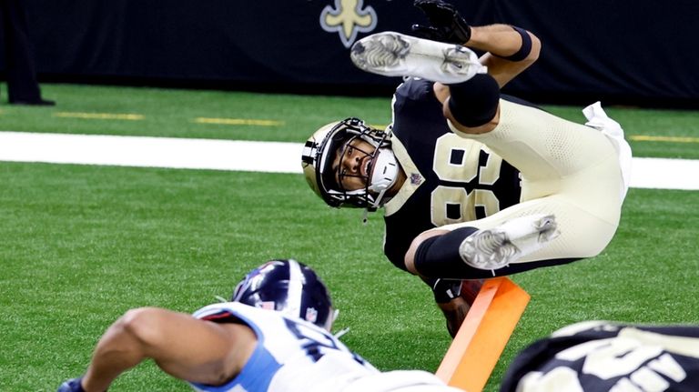 New Orleans Saints' Samson Nacua, top, is knocked out of...