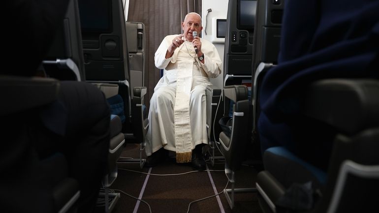 Pope Francis holds a news conference aboard the papal plane...