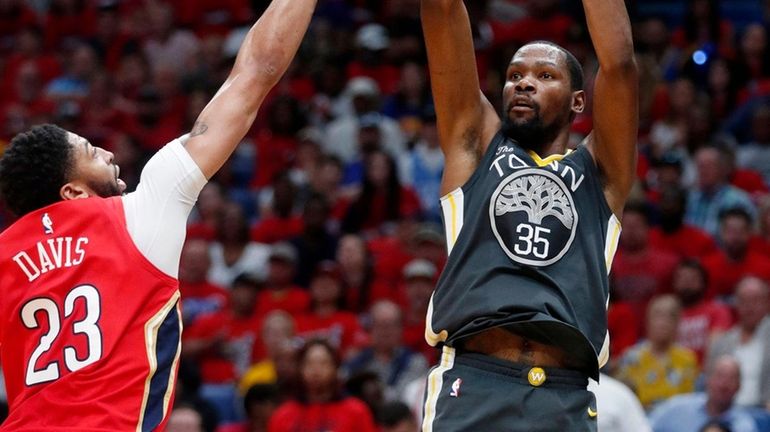 Warriors forward Kevin Durant shoots against Pelicans forward Anthony Davis...