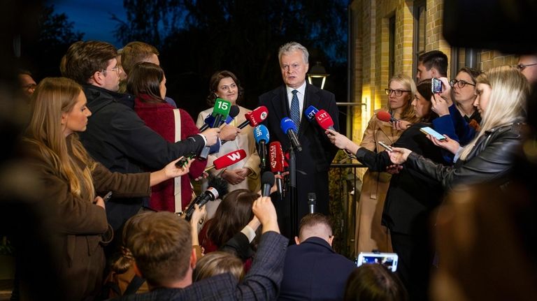 Lithuania's President Gitanas Nauseda, a presidential candidate, and his wife...