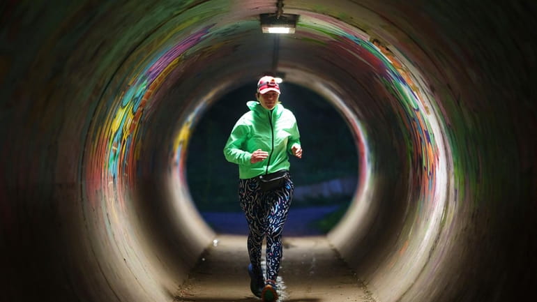 Ultra runner Helen Ryvar runs through an underpass in Wrexham...