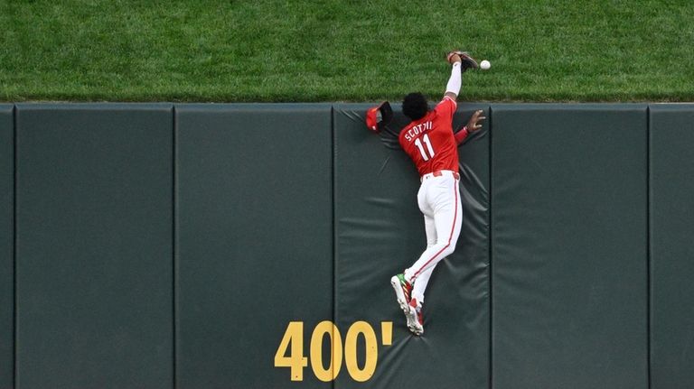 St. Louis Cardinals center fielder Victor Scott II misses a...