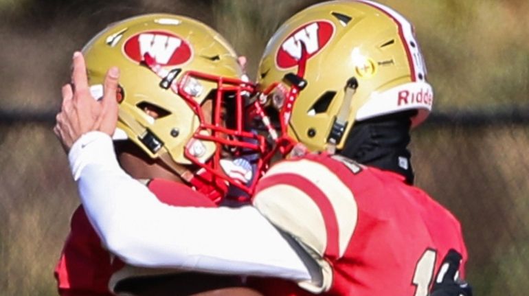 Half Hollow Hills West's Justin Brown (left) and quarterback Gerald...