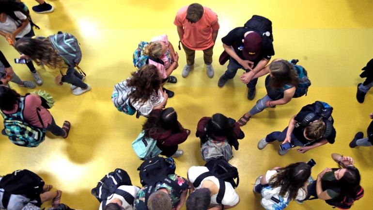 Students gather in a common area as they head to...