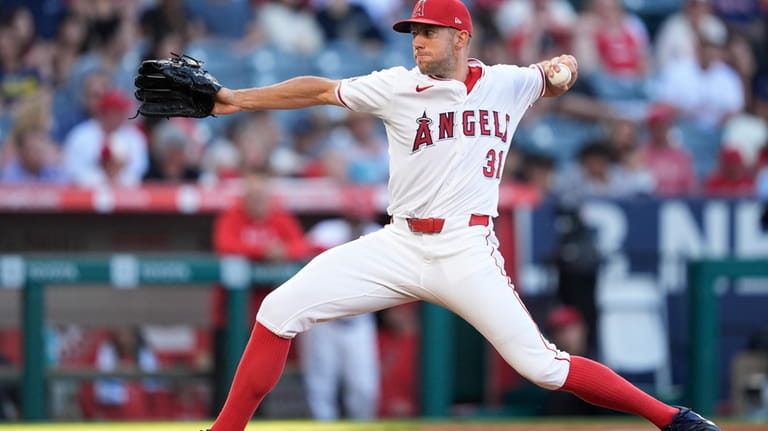 Los Angeles Angels starting pitcher Tyler Anderson throws to a...