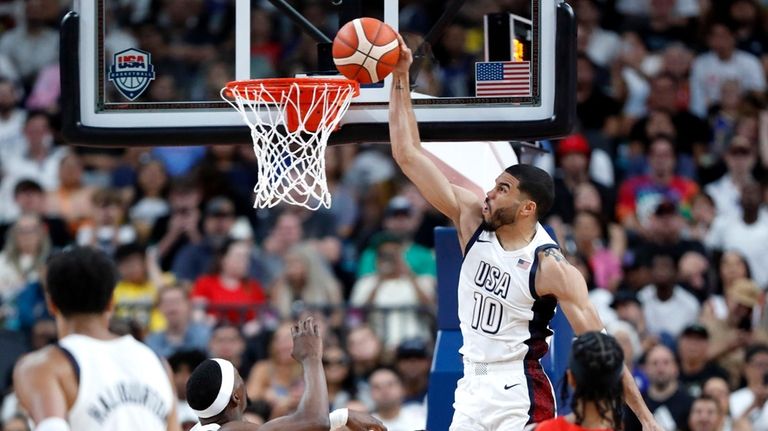 United States forward Jayson Tatum (10) tries to dunk the...