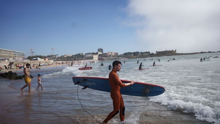 Surf Church's pastor, the Rev. Samuel Cianelli, walks into the...