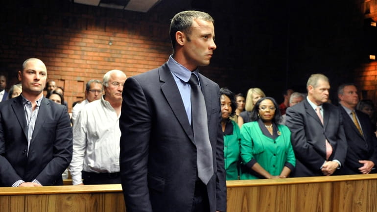 Olympian Oscar Pistorius stands following his bail hearing in Pretoria,...
