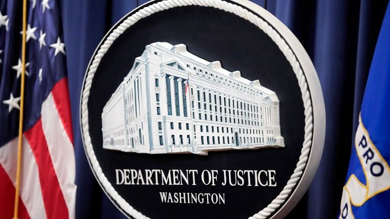 The logo for the Justice Department is seen before a...