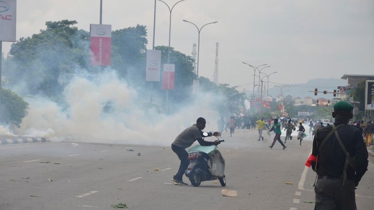 Police fired tear gas during a protest in Abuja, Nigeria,...