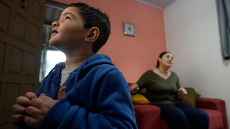 Four-year-old Murillo, who suffers from severe epilepsy, watches TV at...