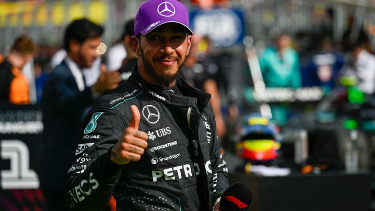 Mercedes driver Lewis Hamilton of Britain celebrates his third place...