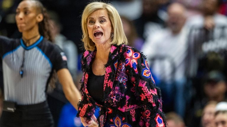 LSU head coach Kim Mulkey, center, yells for a call...