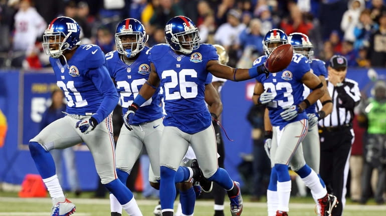 Antrel Rolle celebrates his fumble recovery during a game against...