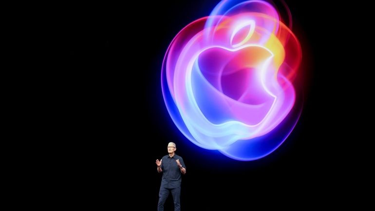 Apple CEO Tim Cook talks on the stage during an...