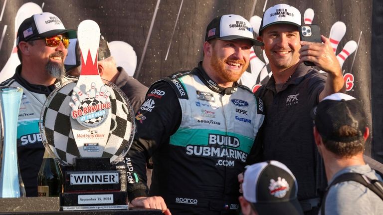 Chris Buescher's (17) team celebrates after winning a NASCAR Cup...