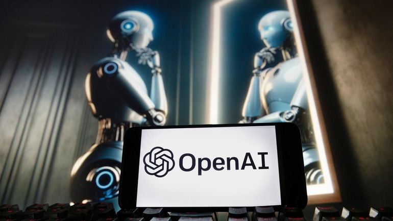 The OpenAI logo is displayed on a cellphone with an...