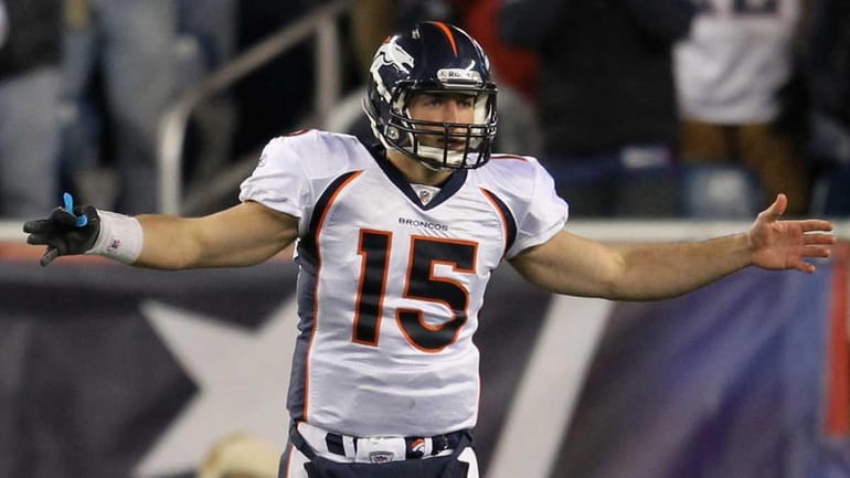 Tim Tebow gestures as he reacts against the New England...