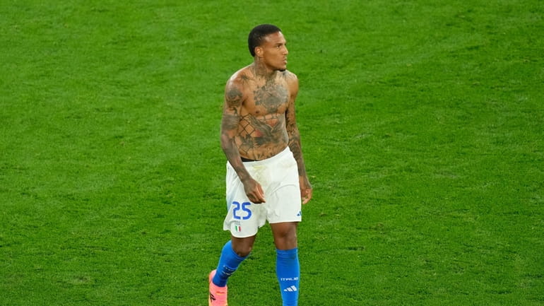 Italy's Michael Folorunsho walks on the pitch at the end...