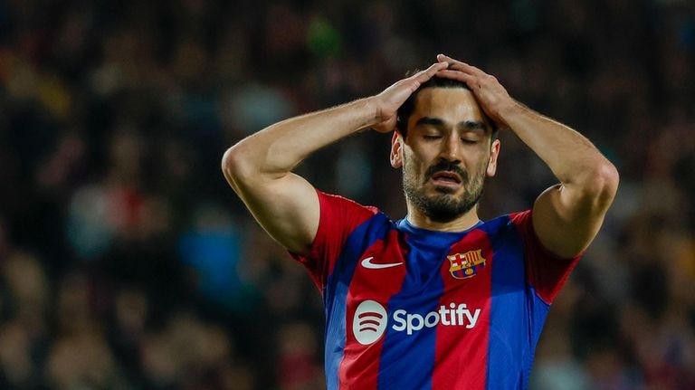 Barcelona's Ilkay Gundogan reacts after missing a chance to score...