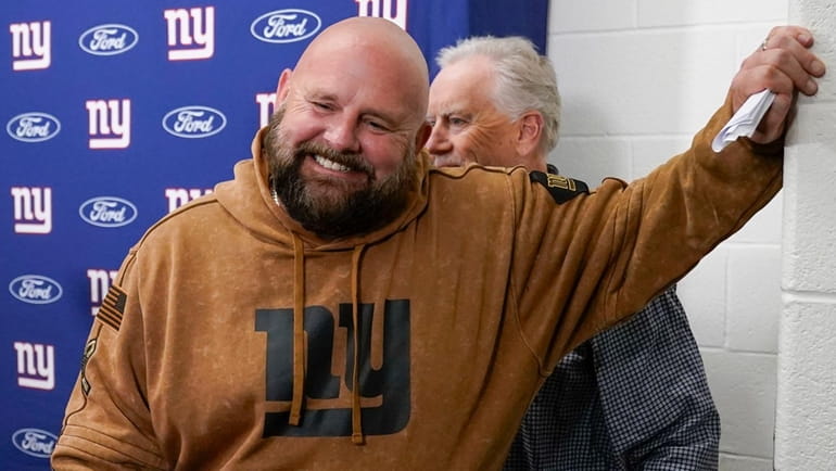 Giants head coach Brian Daboll smiles during his news conference...