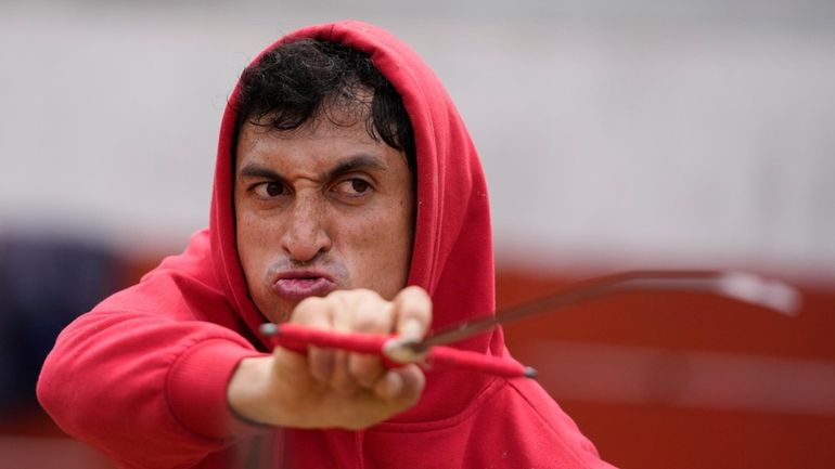 Colombian bullfighter Jose Luis Vega, 30, aims his sword as...