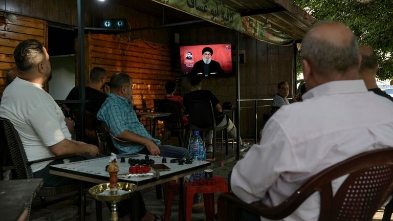 People listen to a speech by Hezbollah leader Sayyed Hassan...