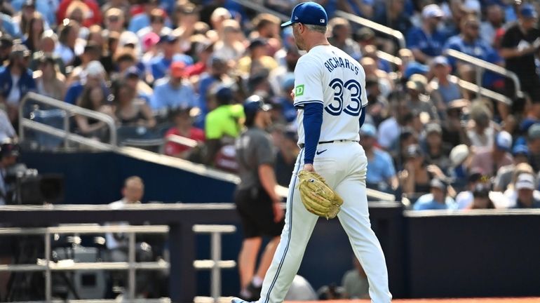 Toronto Blue Jays relief pitcher Trevor Richards (33) exits the...