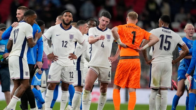 England players react after losing the International friendly soccer match...