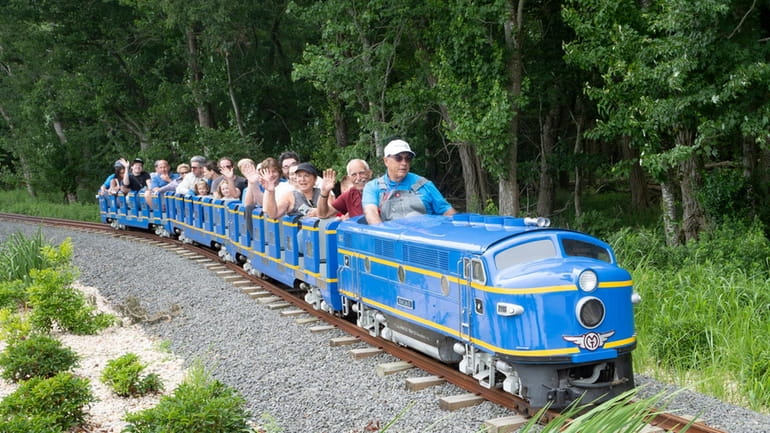 Visitors boarded the Greenport Express miniature railroad for its grand...