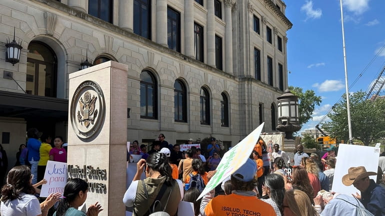 Opponents of an Iowa immigration law rally outside the federal...
