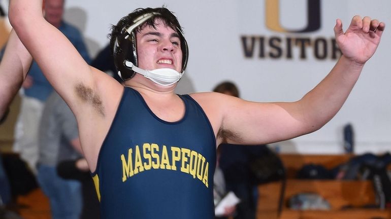 Ethan Pravato of Massapequa reacts after his overtime victory by...