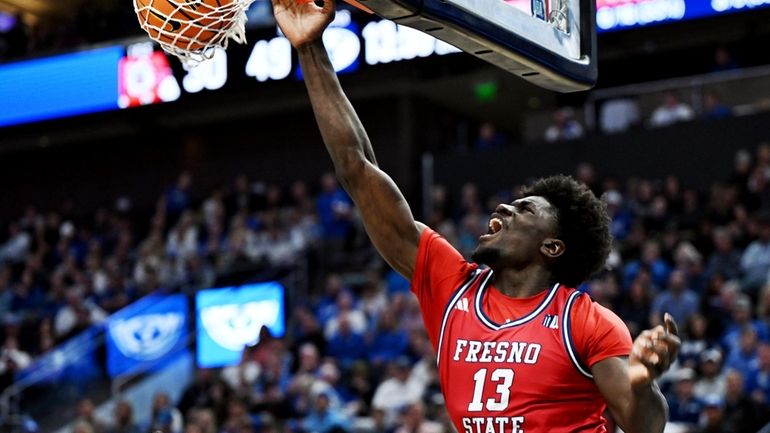 Fresno State center Enoch Boakye (13) dunks over BYU center...