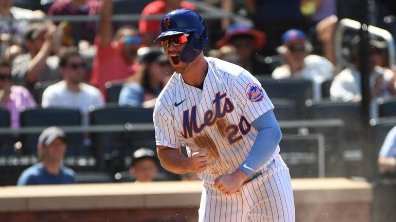 Mets' Pete Alonso reacts after he scored against the Philadelphia...