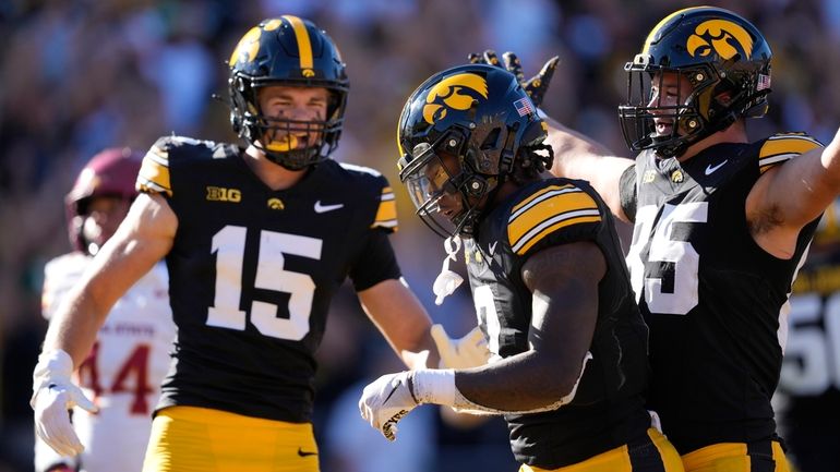 Iowa running back Kaleb Johnson (2) celebrates with teammates Reece...