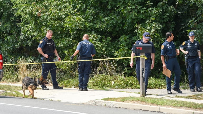 Police at the scene where a 15-year-old was slain in...
