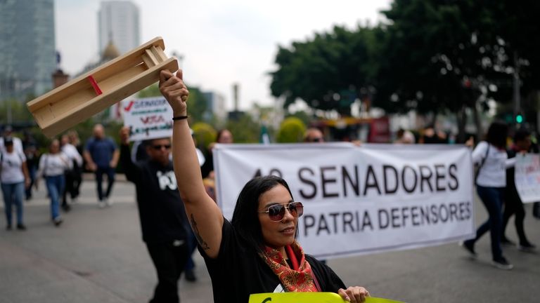 Judicial workers protest the government's proposed judicial reform, which would...